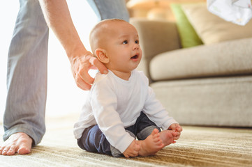 Naklejka premium Father playing with toddler baby son having fun at home in holiday. Family, father, son, baby, Happy, lifestyle concept.