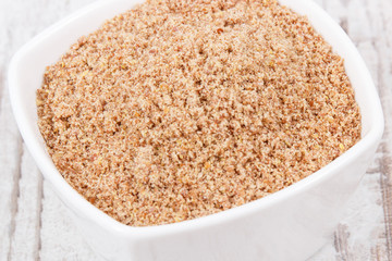 Linseed in glass bowl as healthy food containing vitamins, fiber and acids omega