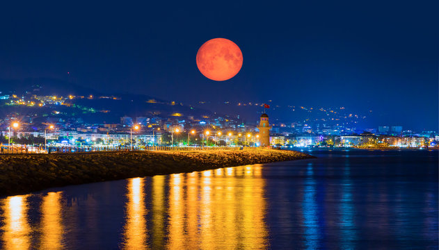 Lighthouse in the port of Alanya with full moon at twilight blue hour - Alanya, Turkey "Elements of this image furnished by NASA"