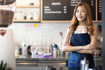Portrait young Asian woman barista feeling happy smiling at urban cafe. Small business owner Korean girl in apron relax toothy smile