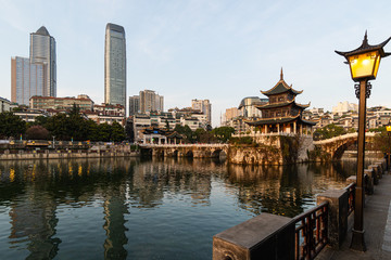 Fototapeta na wymiar View of the Fuyu bridge and Jiaxiu tower in Guiyang old town which contrast with modern towers in Guizhou province in China