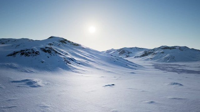 Aerial Landscape of snowy mountains and icy shores in Antarctica