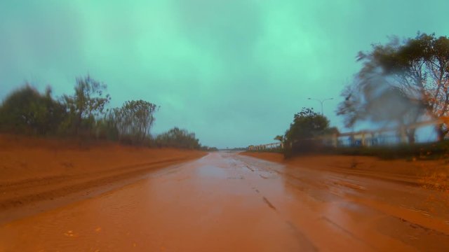 Driving Along Dirt Road In Heavy Rain Muddy Water Spray - Blake