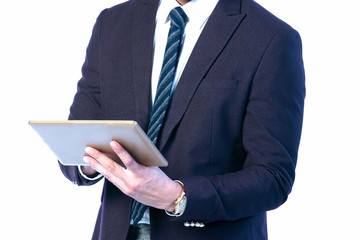 Tablet in the hands of a business man wearing a suit. Working to analyze marketing for online trading.on a white background.