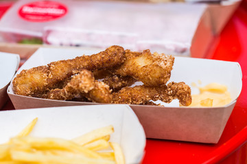 Fresh fried chicken on a white card plate