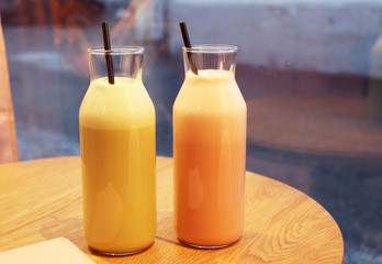 Smoothie with a metal tube, coffee raff with cherry and mint