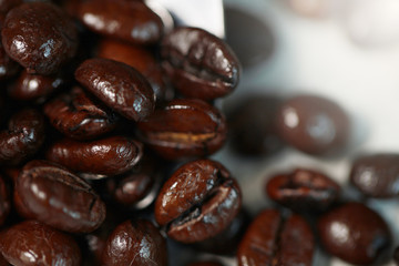 Closeup coffee beans and coffee cream on the spoon for the good taste coffee on white background, coffee seeds 