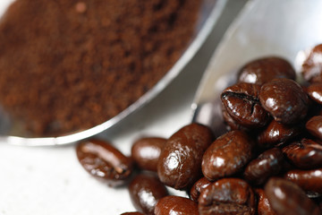 Closeup coffee beans and coffee cream on the spoon for the good taste coffee on white background, coffee seeds 