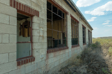 Broken out windows on the side of an abandoned building