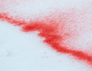 spots of red paint on white snow