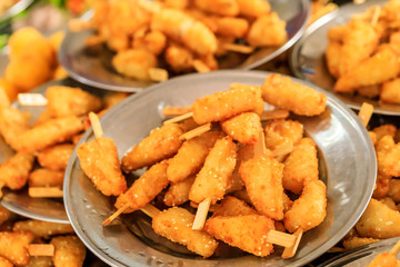 Delicious fried chicken skewers on a plate.
