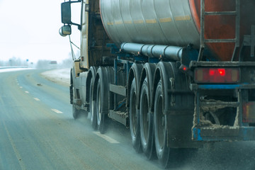 Obraz na płótnie Canvas Fuel trucks passing on the winter road