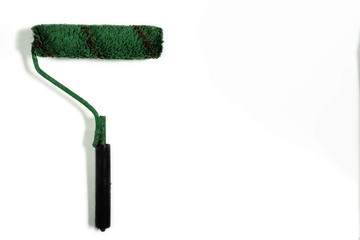 Paint brush roller on white background with copy space. Green used paint tool as a concept of refurbishing, re branding and changes. Mock-up color object