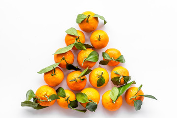 Tangerines with leaves - triangle shape - on white background top-down copy space