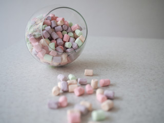 Gentle marshmallow in glass vase isolated on white