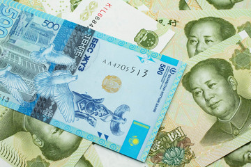 A blue five hundred tenge note from Kazakhstan with Chinese one yuan bills close up in macro