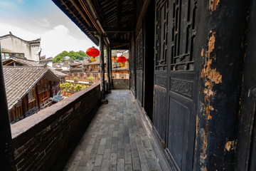 Fototapeta na wymiar Balcony of an old traditional Chinese house. Walls, balcony, windows, everything is made with wood. Fenghuang Ancient Town, Hunan province, China