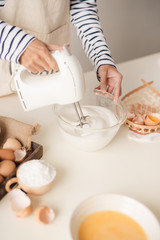 Fototapeta na wymiar Kitchen mixer whipped cream custard pastry whisk rotates rapidly