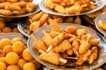 Delicious fried chicken skewers on a plate.