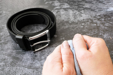 hands squeeze a handkerchief near a black men's belt and notebook, psychological trauma concept,...