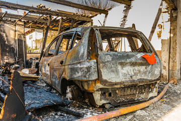 Burnt out car in a garage - police-secured crime scene - forbidden to enter