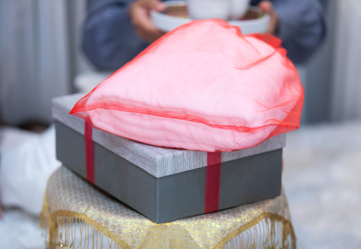 In Chinese Wedding Ceremony, bride and groom prepare wedding gifts or souvenirs wrapped in red clothing or ribbon to relatives and guests as thank for their attendance. Gift and Packaging Idea Concept