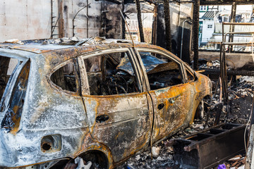 Burnt out car in a garage - police-secured crime scene - forbidden to enter