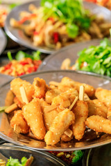 Delicious fried chicken skewers on a plate.