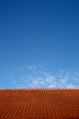minimal red roof on clear blue sky