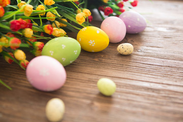 Fototapeta na wymiar Easter eggs on wooden background. Colorful pastel easter eggs on wooden board background