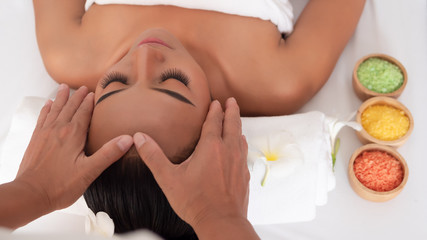 Obraz na płótnie Canvas Top view Asian girls a relaxing facial massage in the Spa Salon. Thai massage for health