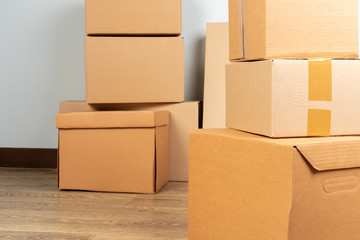 Group of brown carton boxes on wooden floor