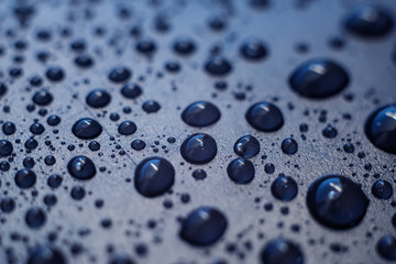 Water drops on plastic surface. Macro with shallow depth of field.