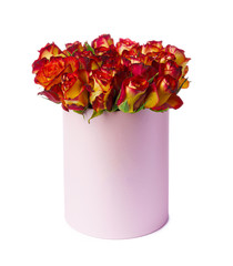 Red and yellow roses in a hat box isolated on white background