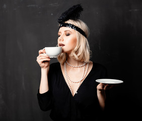 woman in twenties years clothes with cup of coffee