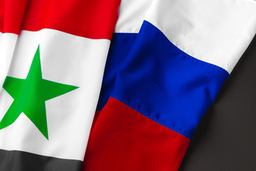 Flags of Russia and Syria together on black