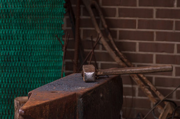 Anvil with a hammer lying on it