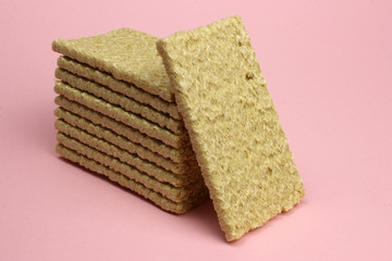 A stack of Crispbread on a pink background. Diet, proper nutrition, Vegan