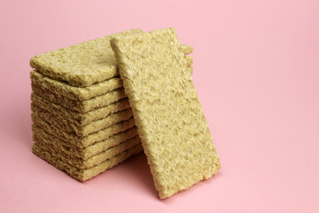 A stack of Crispbread on a pink background. Diet, proper nutrition, Vegan