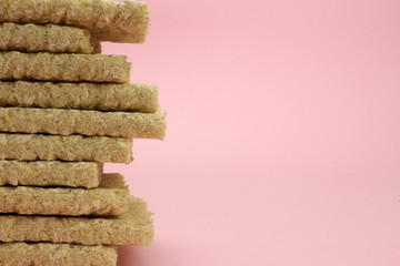 A stack of Crispbread on a pink background. Space for text. proper nutrition, Vegan