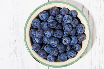 fresh juicy blueberries in a bowl, top view