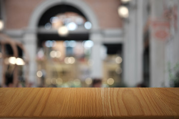 Empty dark wooden table in front of abstract blurred bokeh background of restaurant . can be used for display or montage your products.Mock up for space.