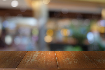 Empty dark wooden table in front of abstract blurred bokeh background of restaurant . can be used for display or montage your products.Mock up for space.