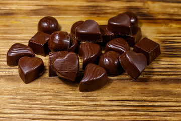 Tasty chocolate candies on wooden table