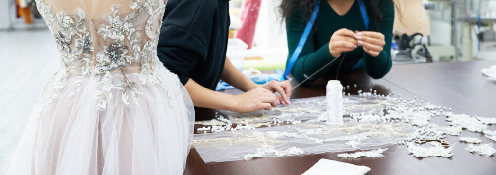 Mannequin With A Wedding Dress Is In The Tailor's Shop. Dressmaker Working In Atelier.