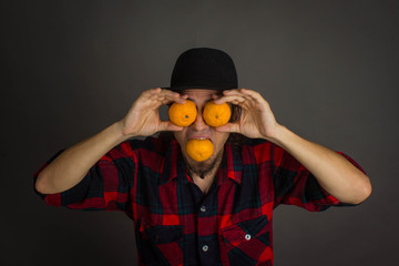 A young man with oranges