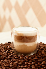 A cup of coffee in coffee beans. Coffee background