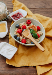 Oatmeal with berries and honey in bowl