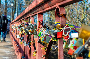 Fototapeta na wymiar Parkovy Bridge with lot of love locks designed by Paton in Kyiv, Ukraine on January 12, 2020. 