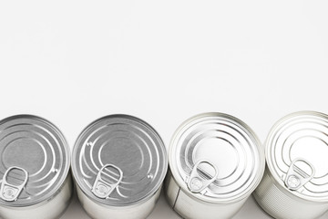 Group of silver canned food on white background.